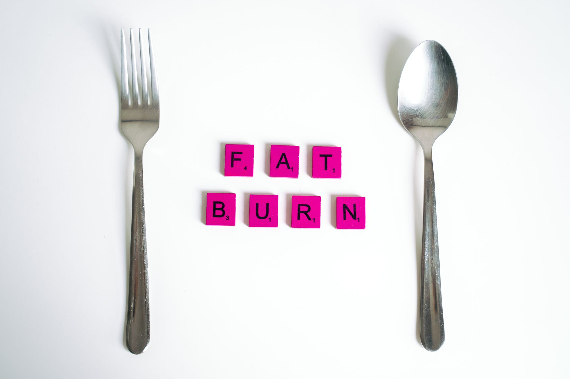 pink scrabble tiles on white background